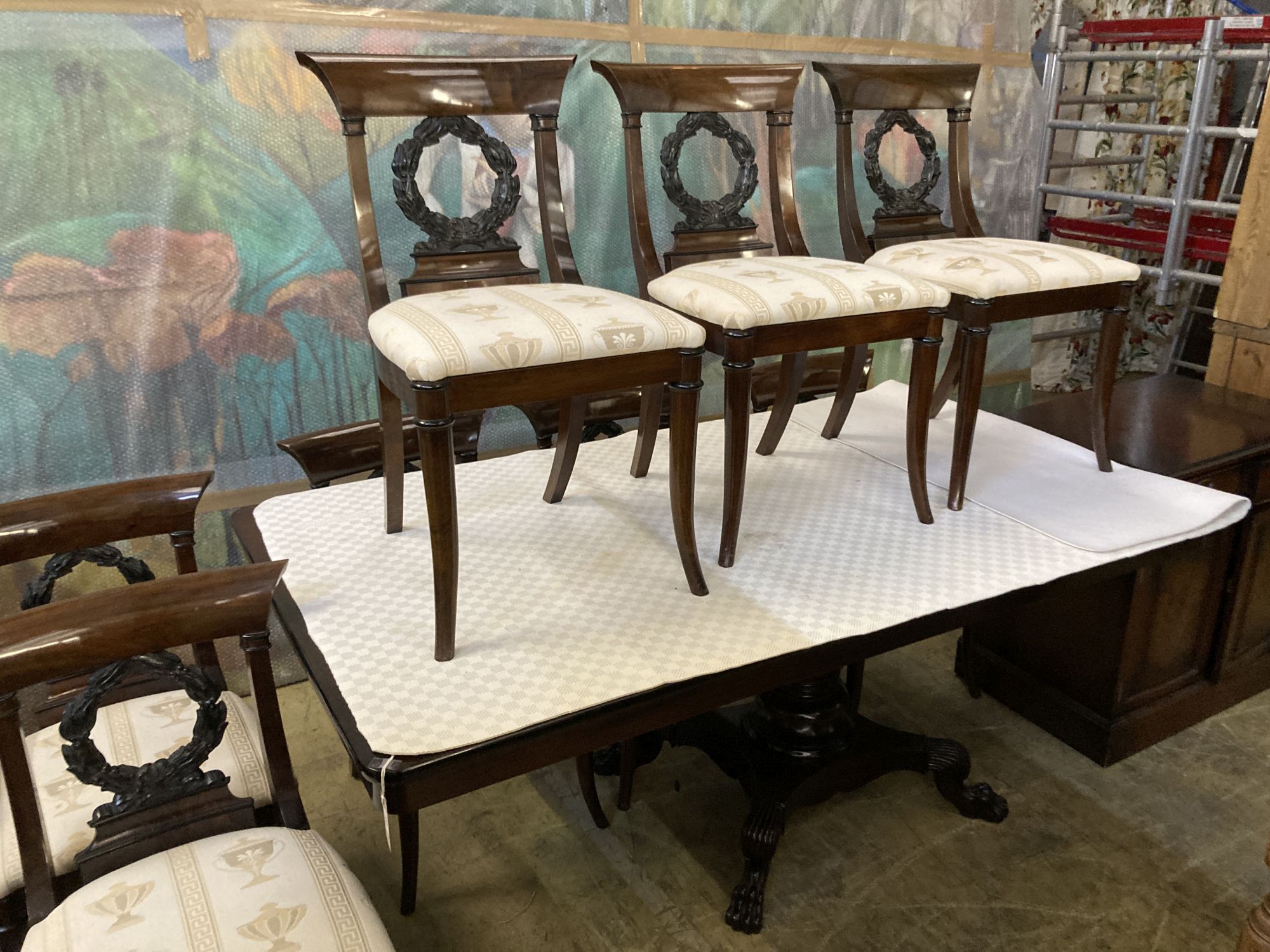 A Regency style mahogany dining suite, comprising rectangular dining table, 176cm extended (one spare leaf), six chairs and a side cabi